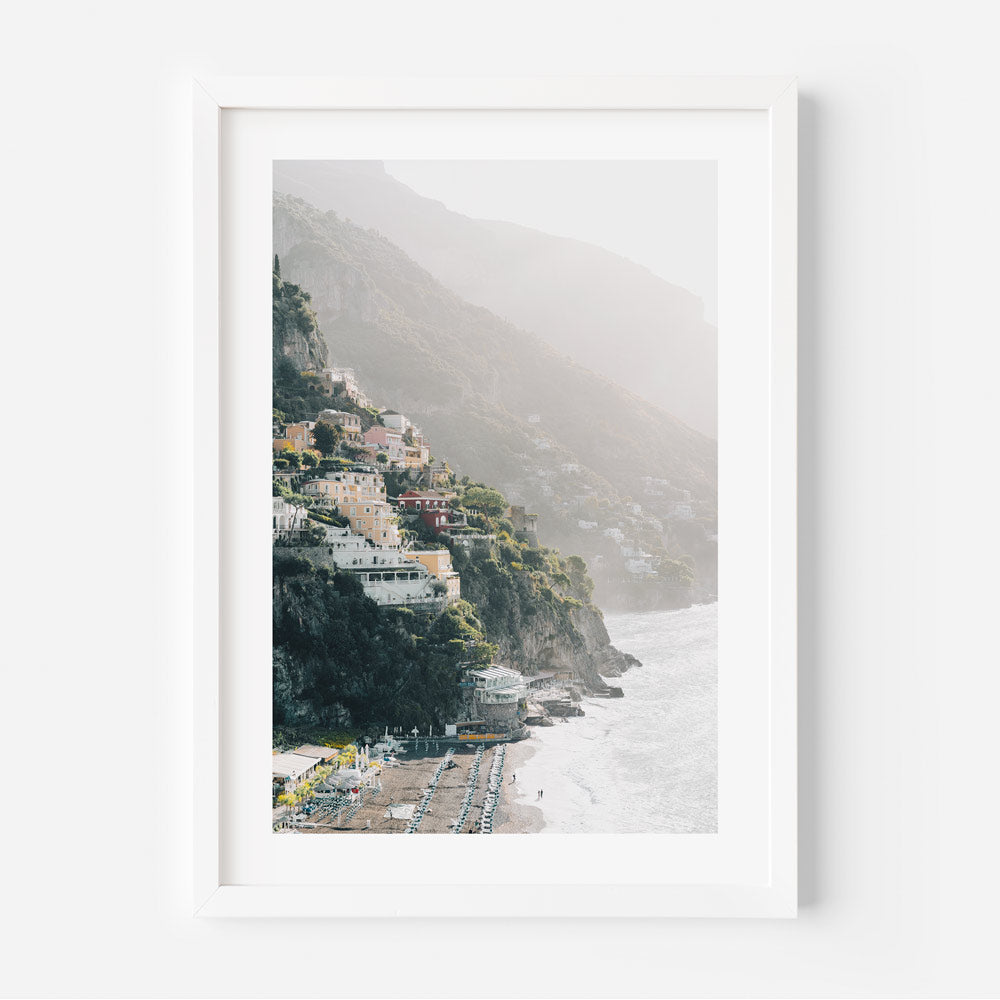 Beach scene wall art of Positano’s colorful buildings and calm shoreline in soft post-rain light