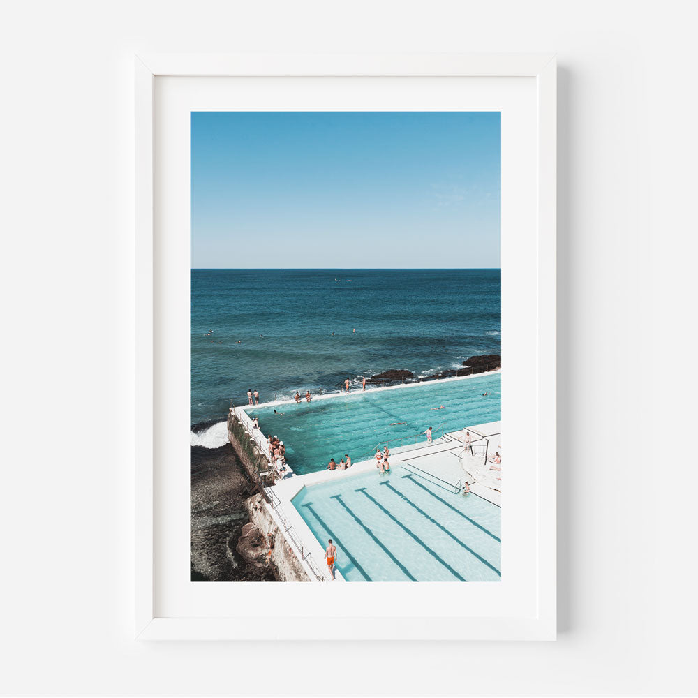 A white framed photo of Bondi Icebergs bathers, a stunning pool and ocean scene.