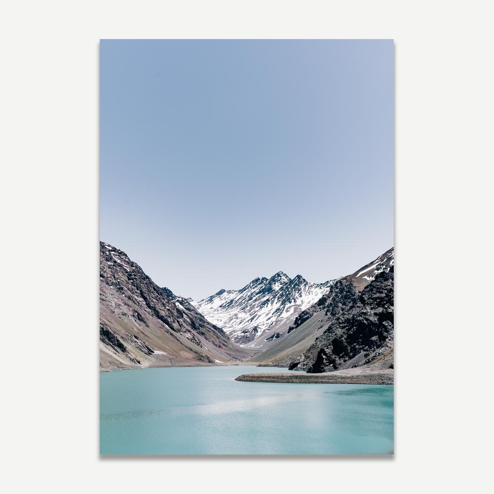 A framed poster depicting a landscape with a lake and snow-capped mountains, predominantly in blue and green shades.