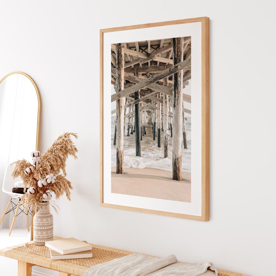 Wall art decor featuring a white framed photo of the ocean under a pier - Real photography from California coast for home and office.