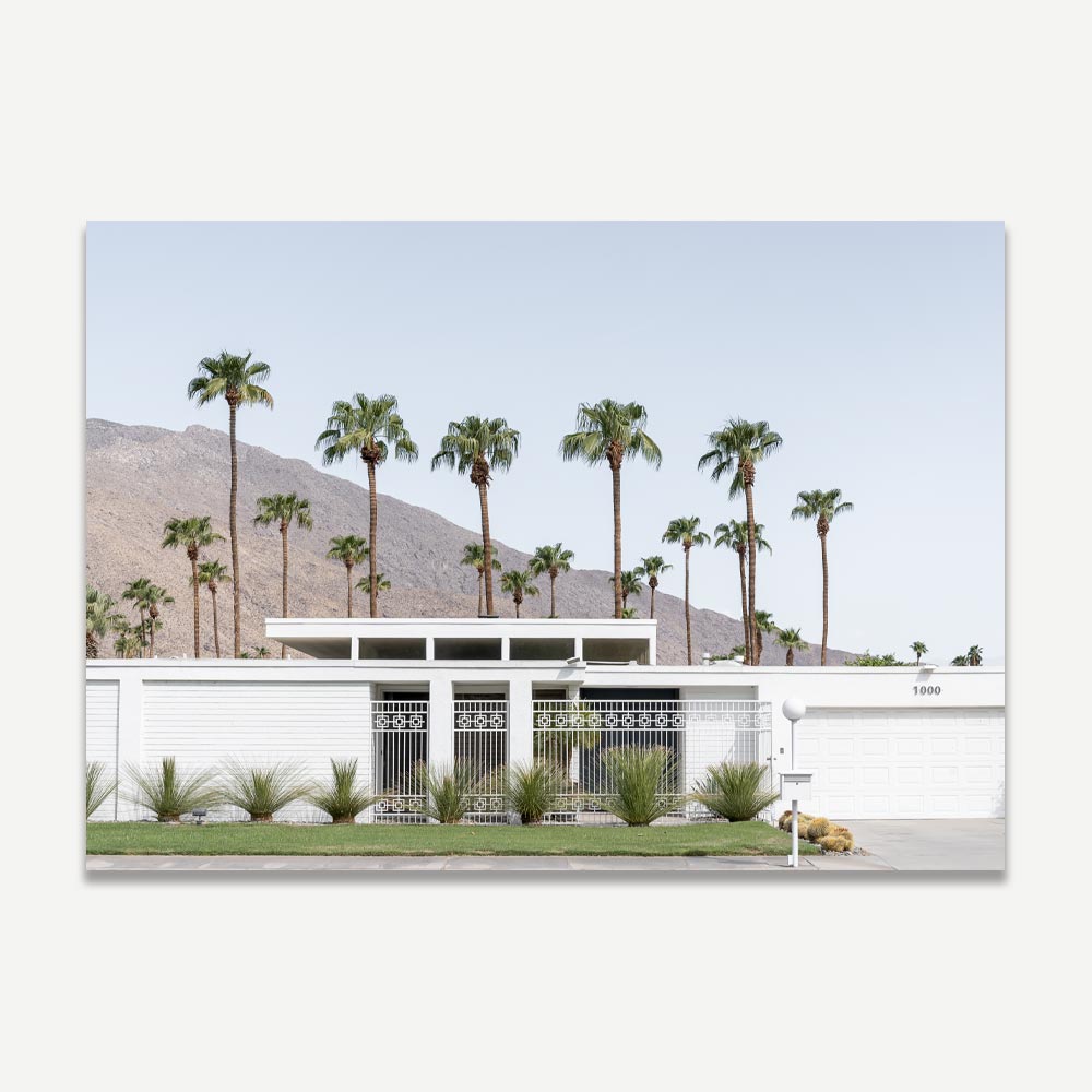 Mid-century modern home facade with palm trees backdrop in Palm Springs