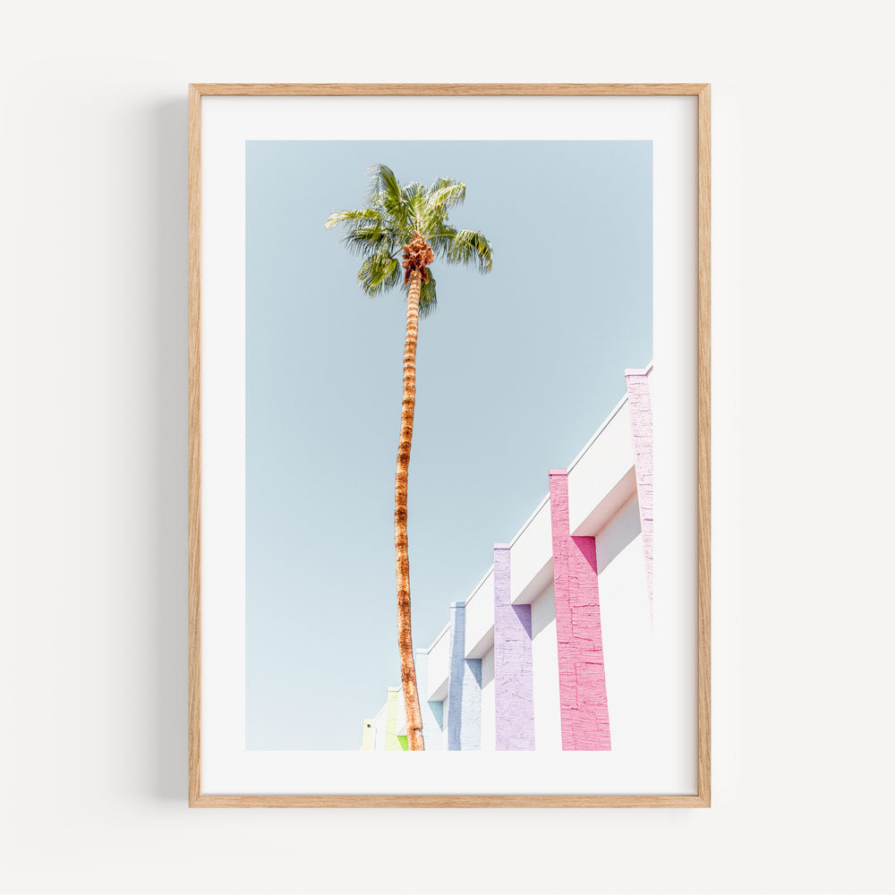 Vibrant wall with palm trees in a golden frame, a captivating piece of wall art by Oblongshop.