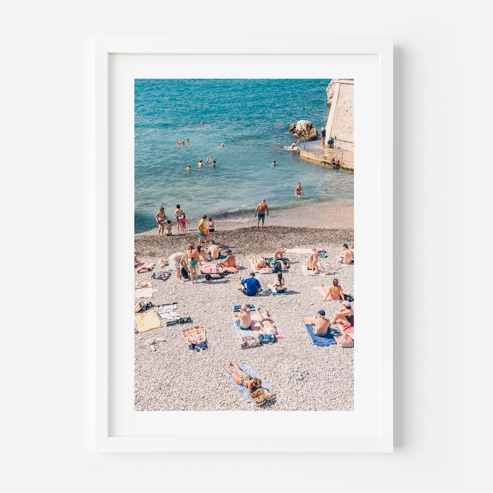 Wall art: Embrace the coastal vibes of "A La Plage," as beachgoers bask in the sun at Nice, Côte d'Azur, France.