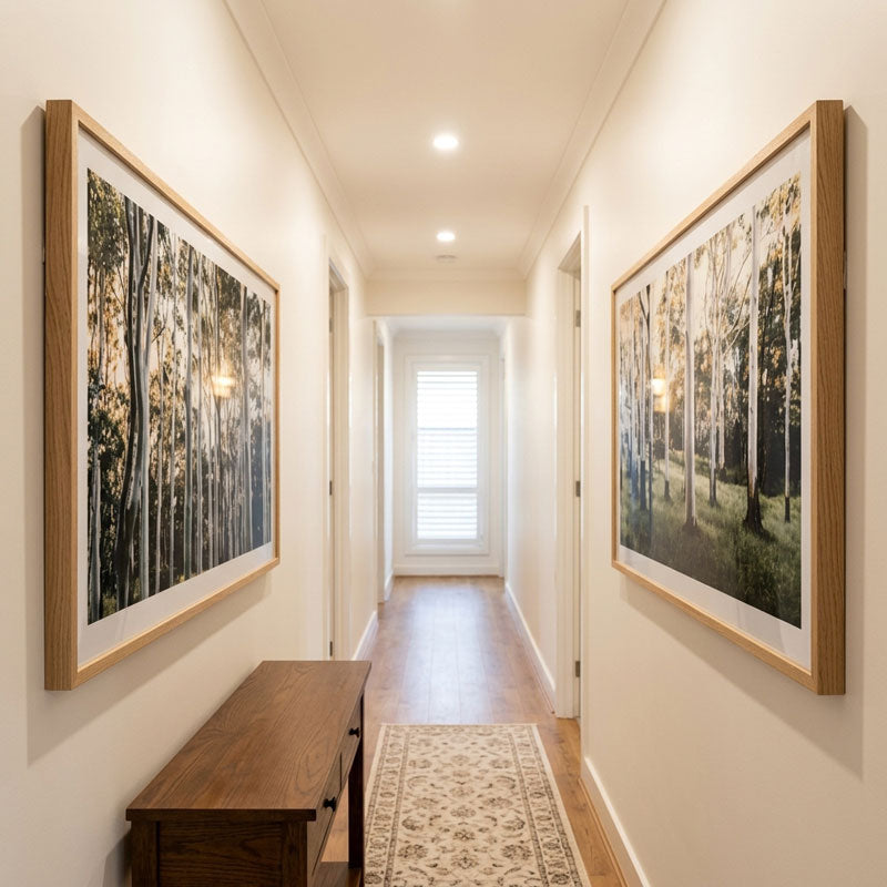 Hallway with framed artwork on the walls and a wooden bench.