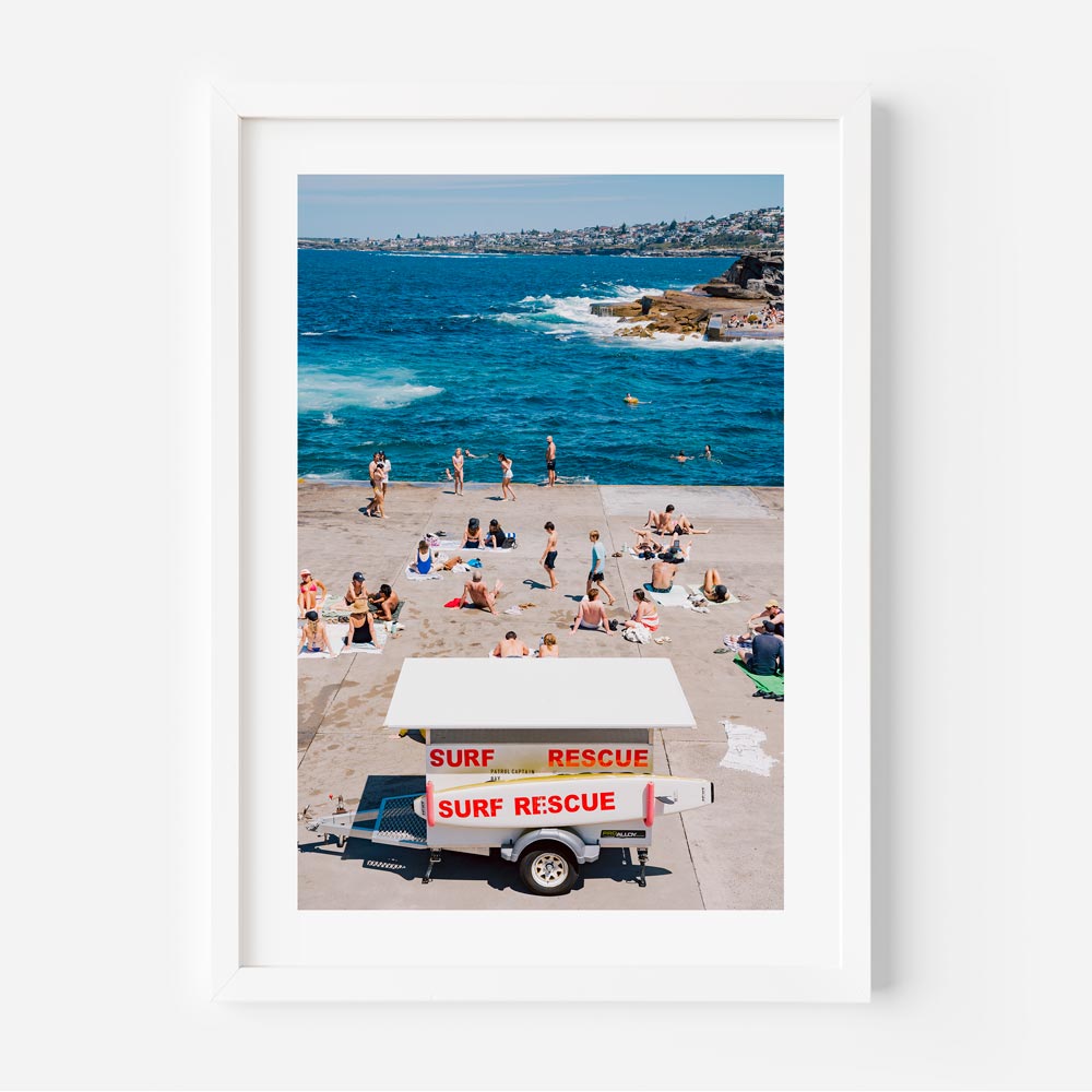 Coastal wall art capturing a serene beach scene at Clovelly, Sydney: People enjoying the sun with Bay Patrol in view.