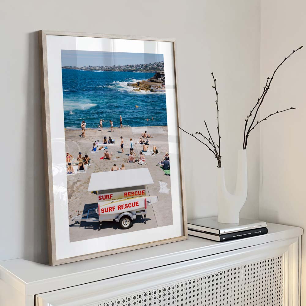 Home decor highlighting a tranquil day at Clovelly, Sydney beach: Bay Patrol keeping watch as people unwind.