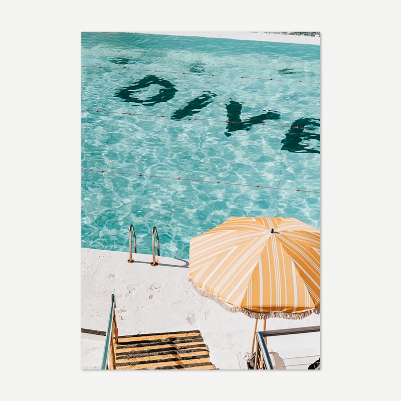 Turquoise water with 'Dive' text, yellow umbrella, and lounge chairs on a white background