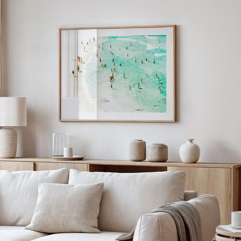 Living room with a sofa, lamp, and framed artwork on the wall.