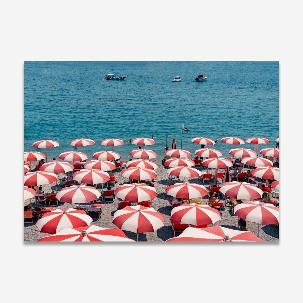 Amalfi Marina Grande summer scene with vibrant red and white beach umbrellas against the deep blue Mediterranean sea – capturing the essence of coastal living and Italian summer bliss.