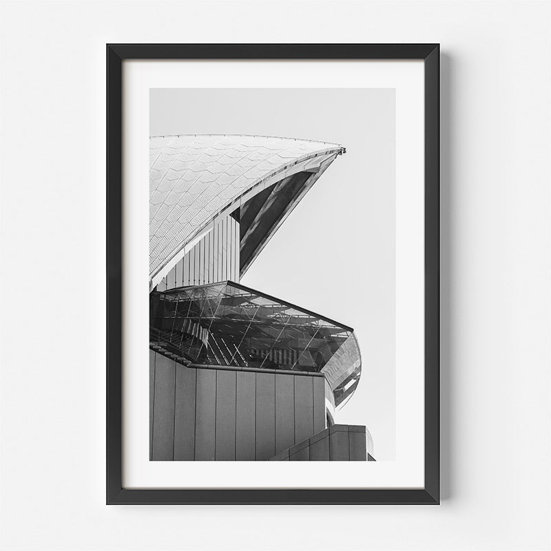 Framed black and white architectural print of a building's facade on a white background