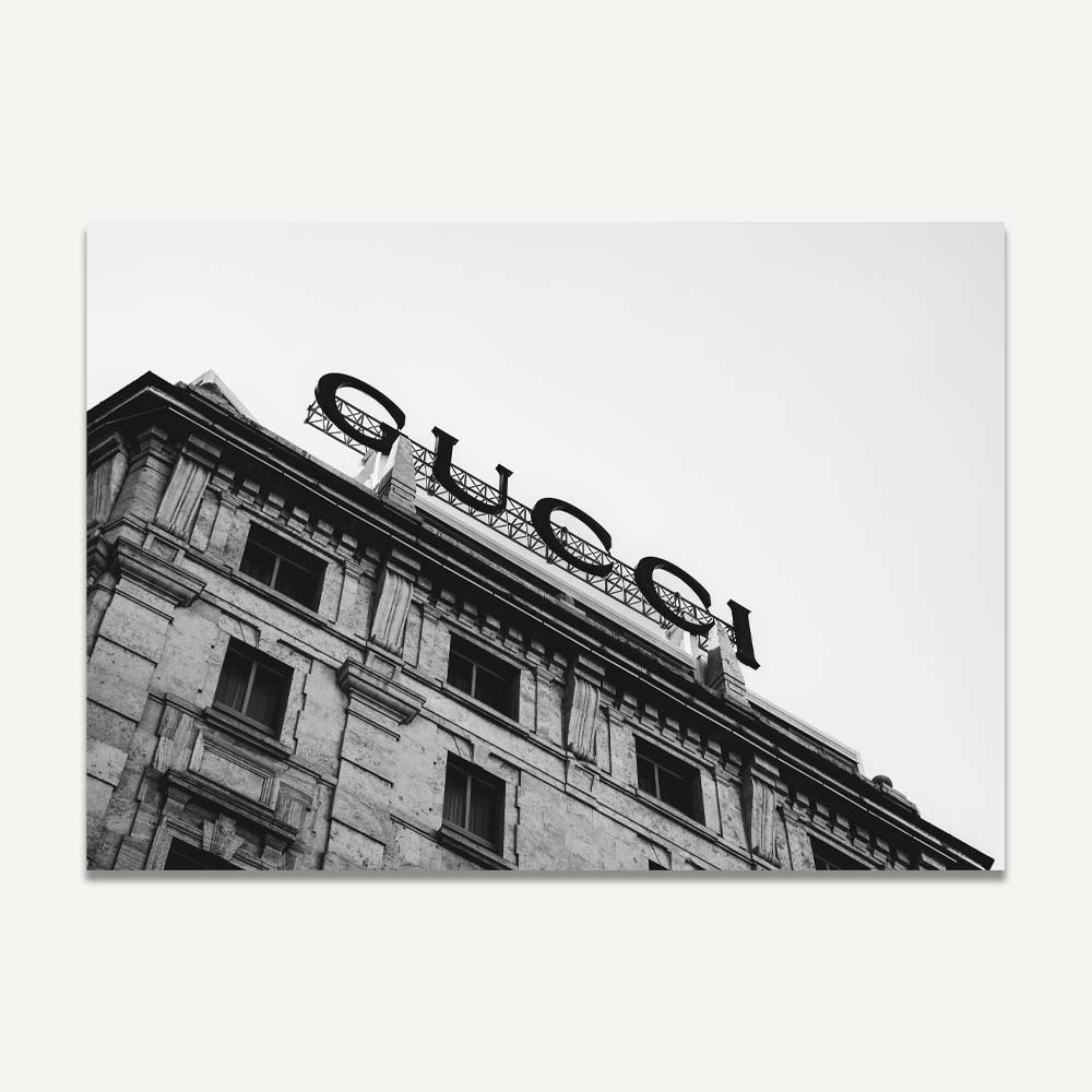 Gucci sign on an old building in Milan – Classic black and white Milan wall art capturing high fashion and architectural elegance for your home decor.