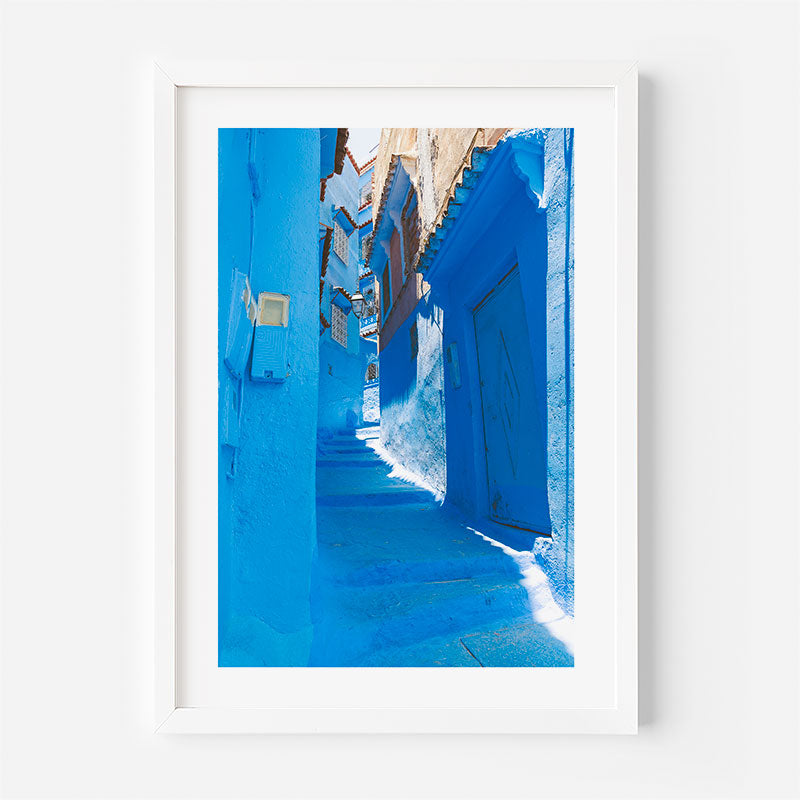 Framed photograph of a narrow blue alleyway