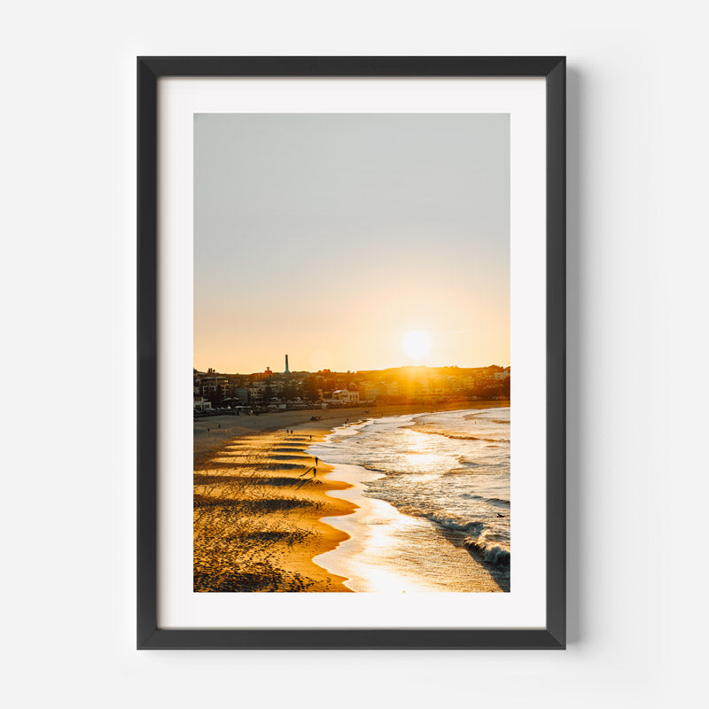 Framed photograph of a beach sunrise with a black frame.