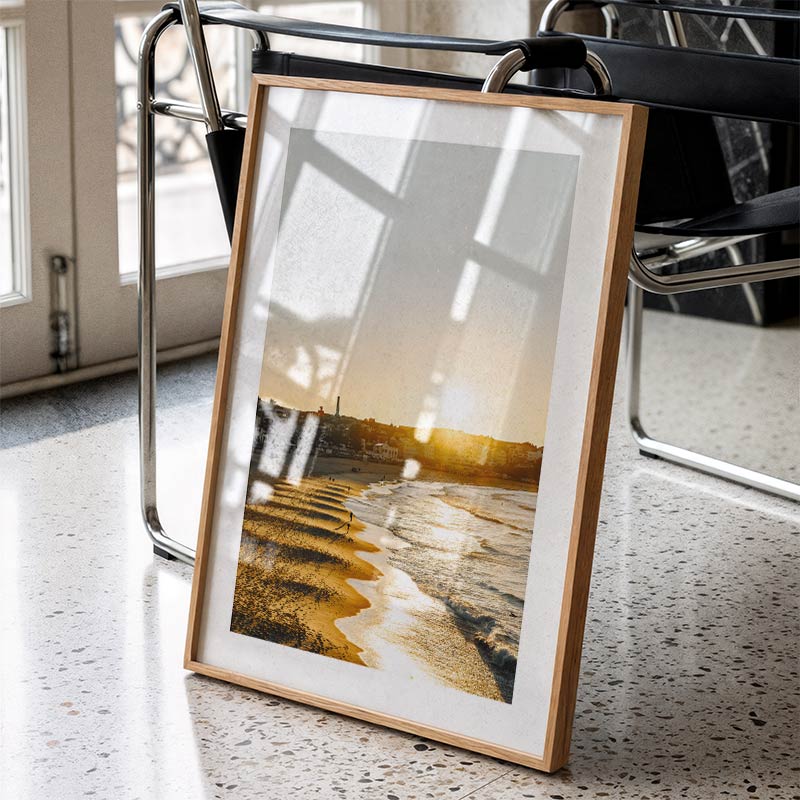 Framed artwork on a table with a chair in the background