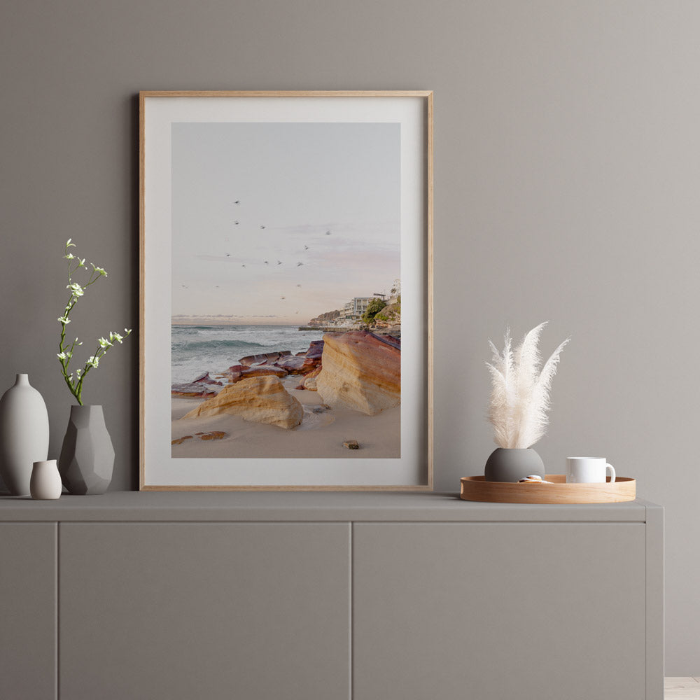 Morning at Rocks Bondi Beach Australia, golden framed photo of beach with birds flying over it.