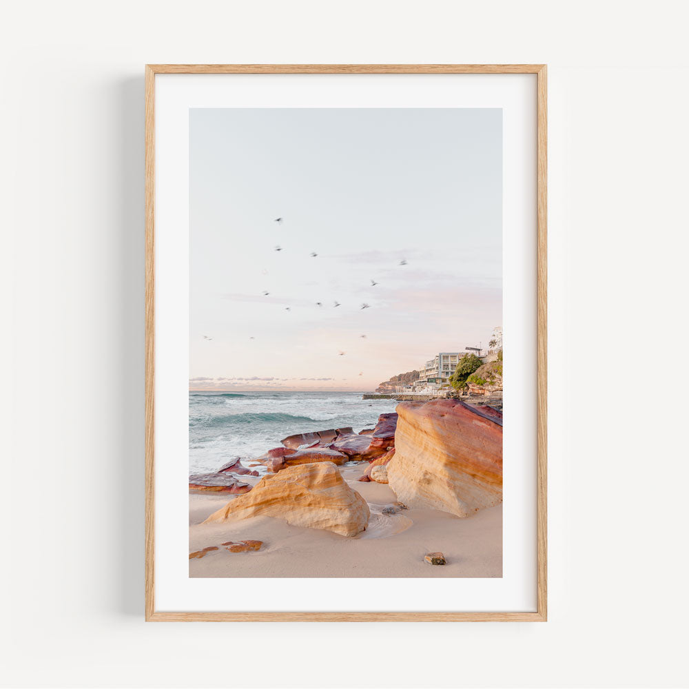 Golden framed photo of beach with birds flying, morning at Rocks Bondi Beach Australia, wall art for home decore