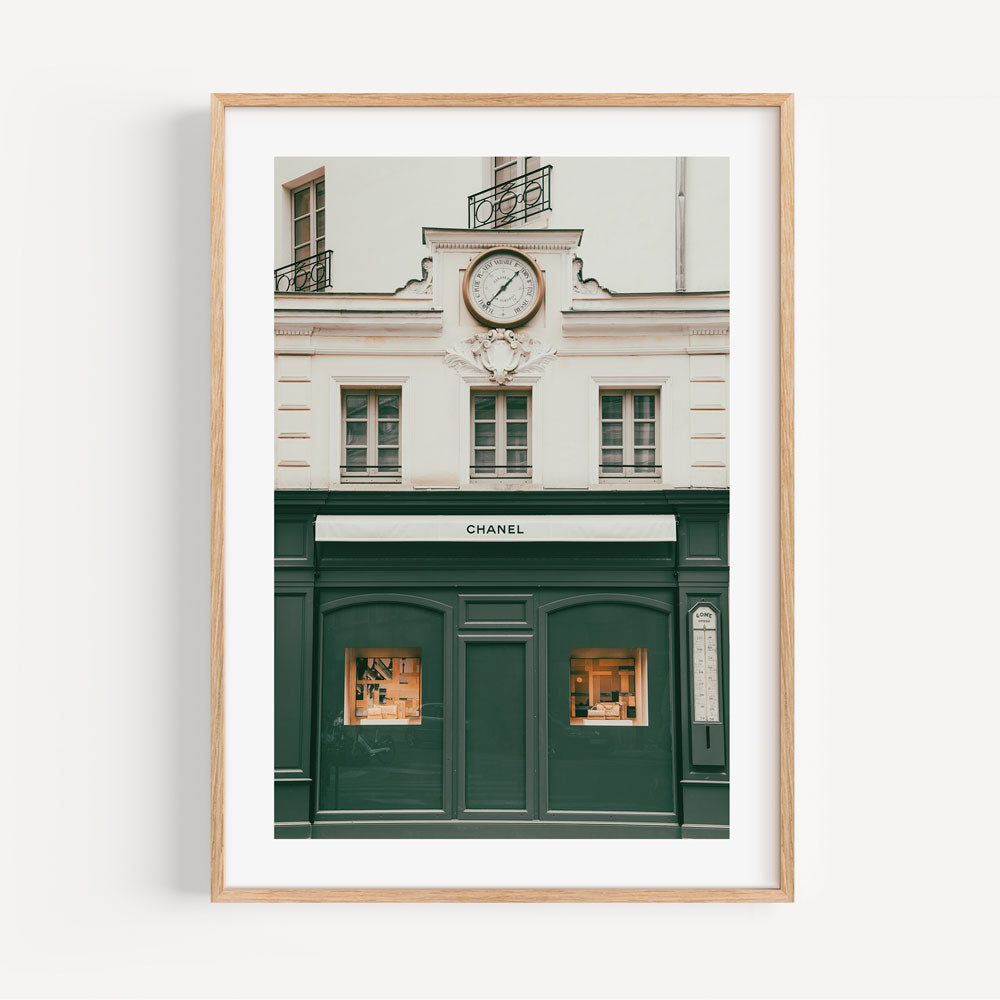 Discover the beauty of the Chanel building in Paris, France, through this framed photo with a clock, ideal for wall art decor.