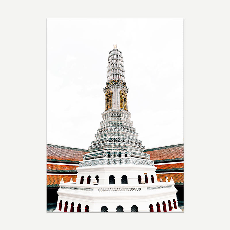 A vertical canvas art print depicting the Grand Chai Phra tower in Bangkok, Thailand, featuring a white and silver tiered pagoda with gold accents against a white sky, shown on a light gray background.