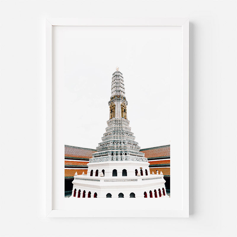 A framed art print featuring a detailed illustration of a white tiered temple tower with gold accents and red roof tiles, set against a white background.