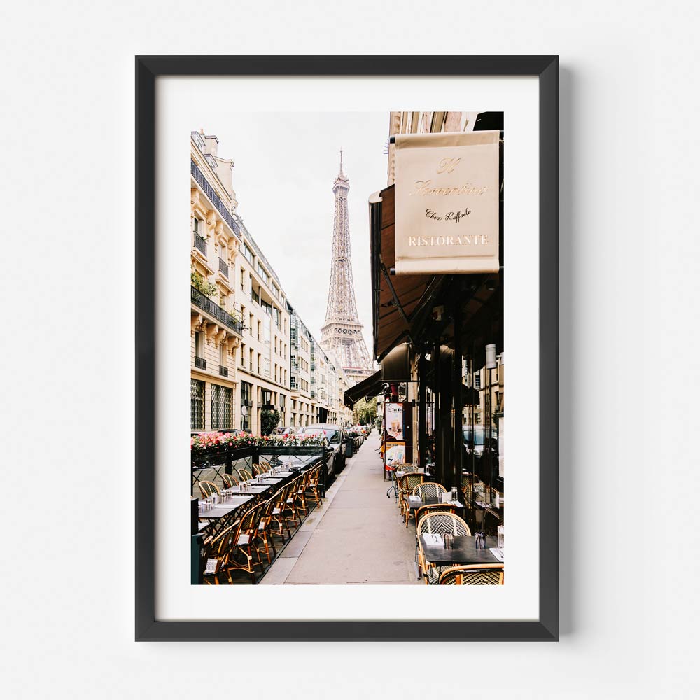 Iconic Eiffel Tower visible from Rue de Monttessuy, surrounded by charming Parisian cafés and buildings.
