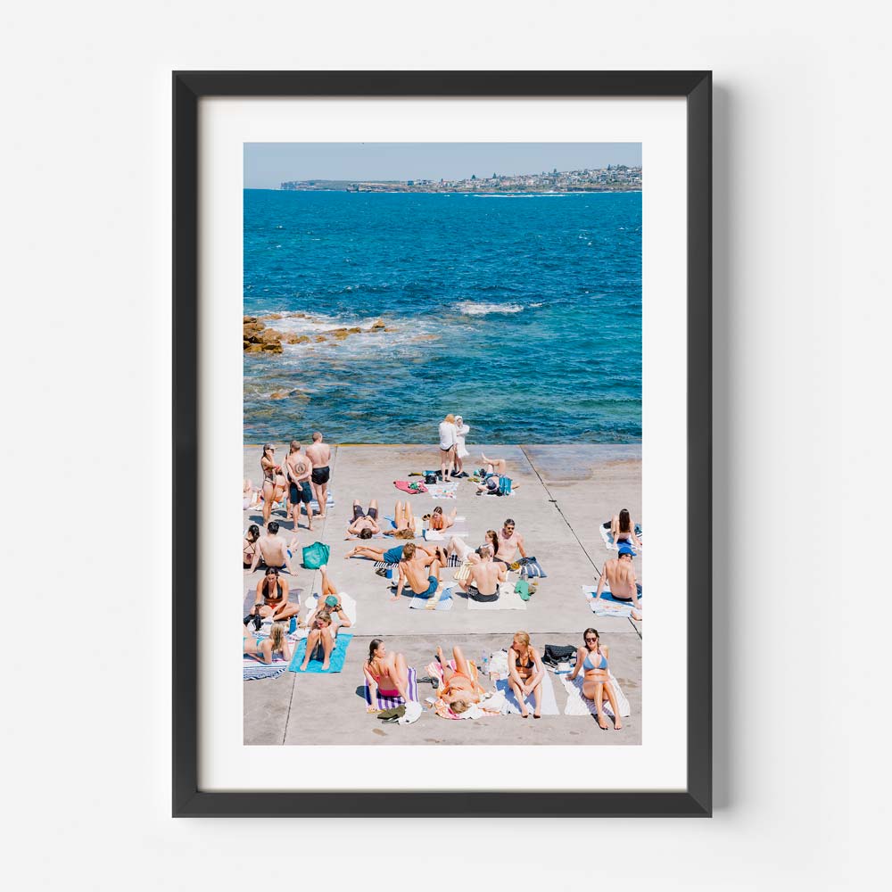 Serene beach ambiance at Clovelly, Sydney: People soaking up the sun and sea - Enhance your home decor with this real photography.