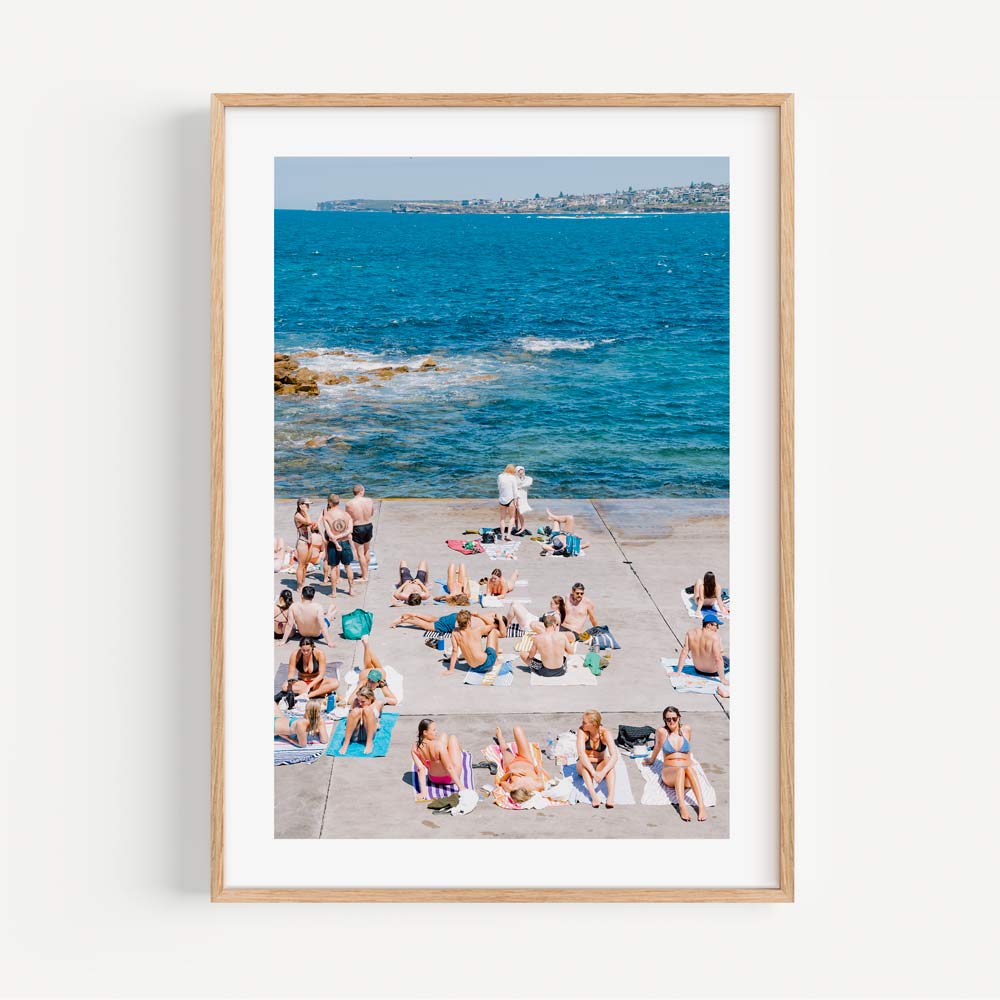 Relaxing beach scene in Clovelly, Sydney: People basking in the sun and sea - Stylish wall art to transform your living space.