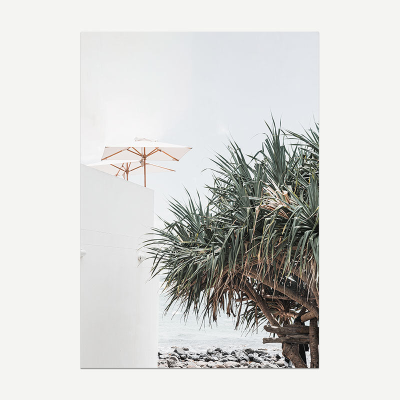 Beach scene with palm tree and umbrella on a white background