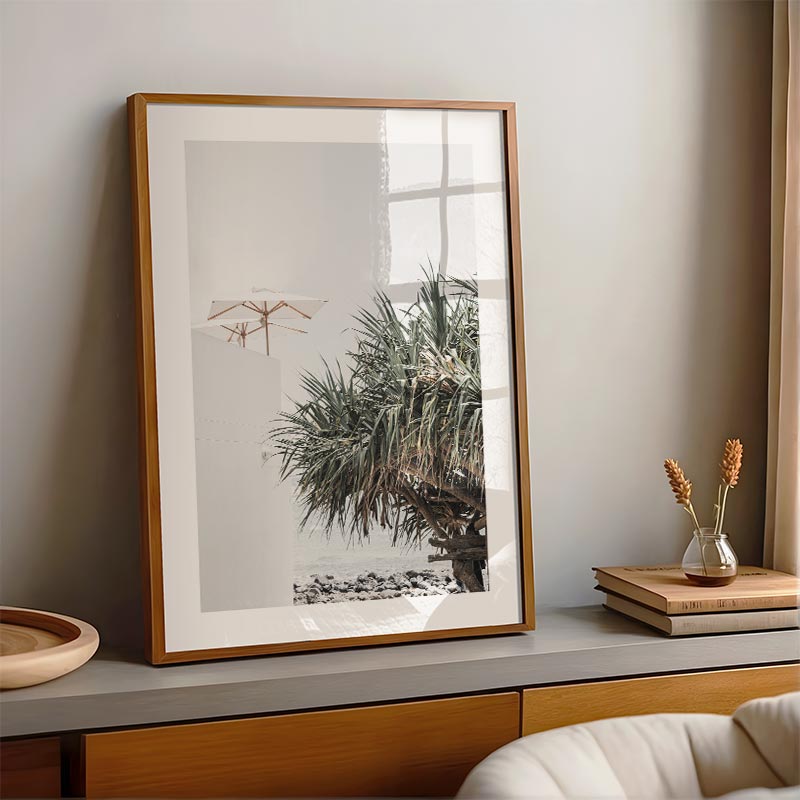 Framed artwork on a shelf with decorative items