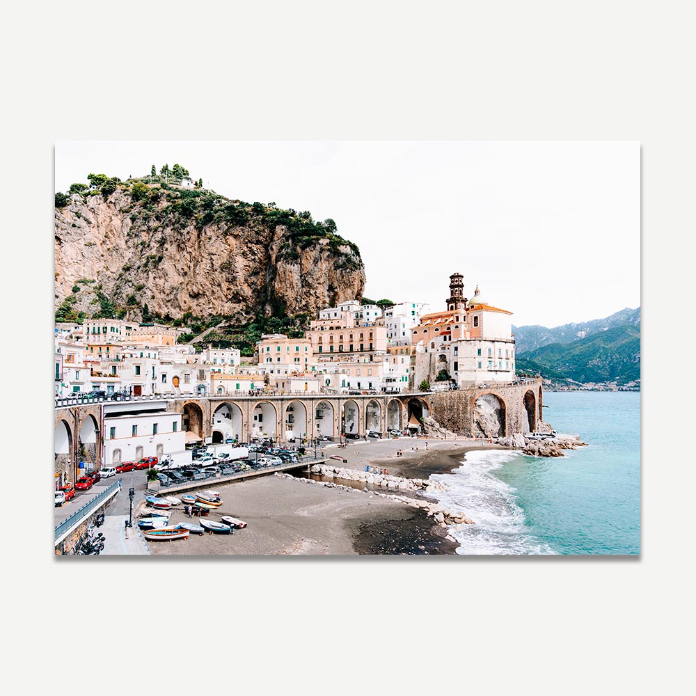 Wall art of Atrani’s cliffside homes on the Amalfi Coast in soft, desaturated tones. Elevate your home or office with this captivating wall art showcasing a beach and mountain landscape.