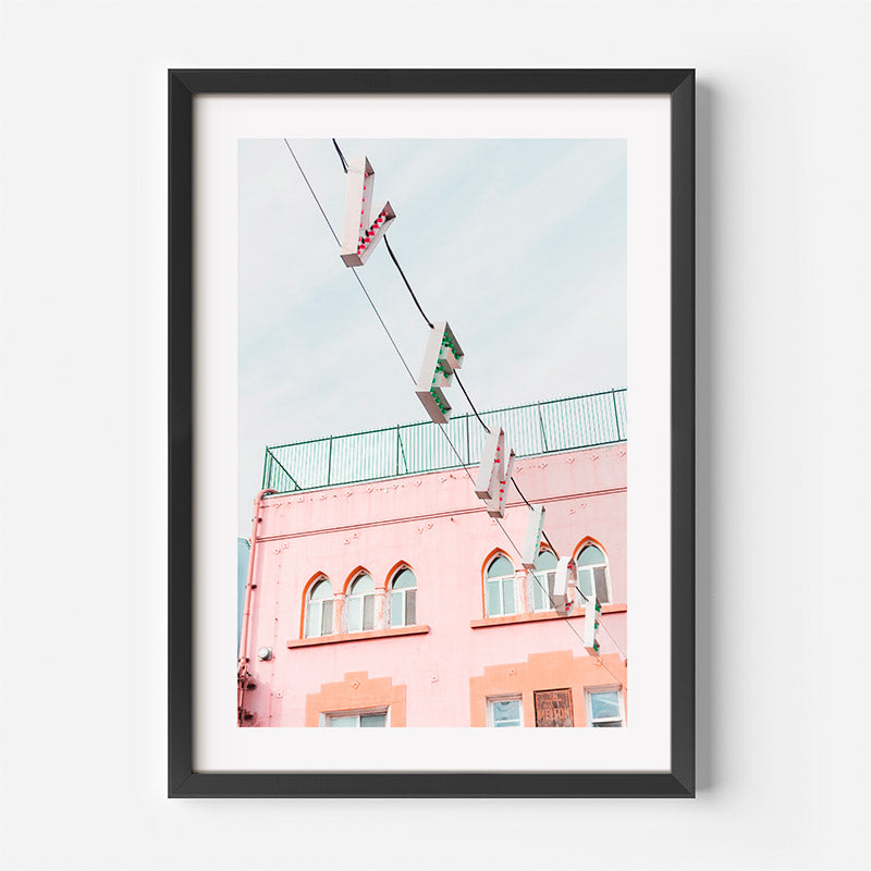 Framed photograph of a pink building with a clear sky