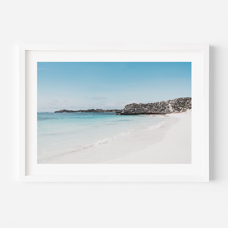 Framed photograph of a beach with clear blue water and sky.