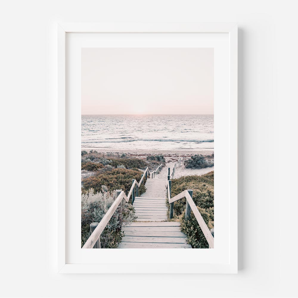 A framed photo of Cottesloe Beach, Perth Western Australia, with stairs leading to the ocean at sunset. Perfect wall art for your home or office.