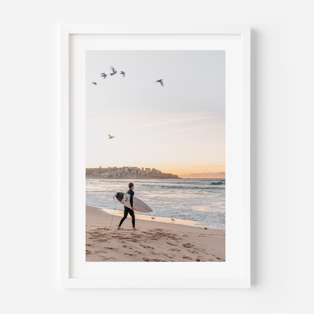 Morning Surf: Dawn surfer catching waves at Bondi Beach, capturing the beauty of the sunrise over the ocean.
