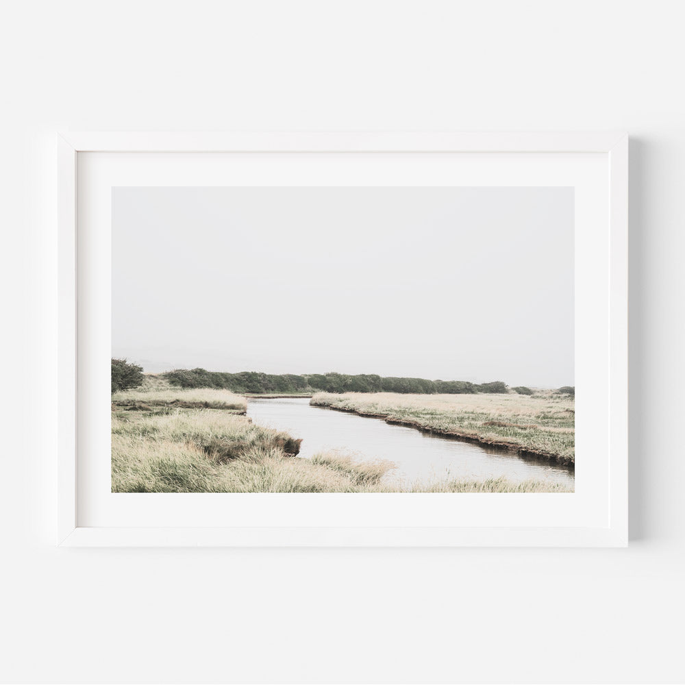 A serene river flowing through a picturesque field in the English countryside, perfect for wall art decor.