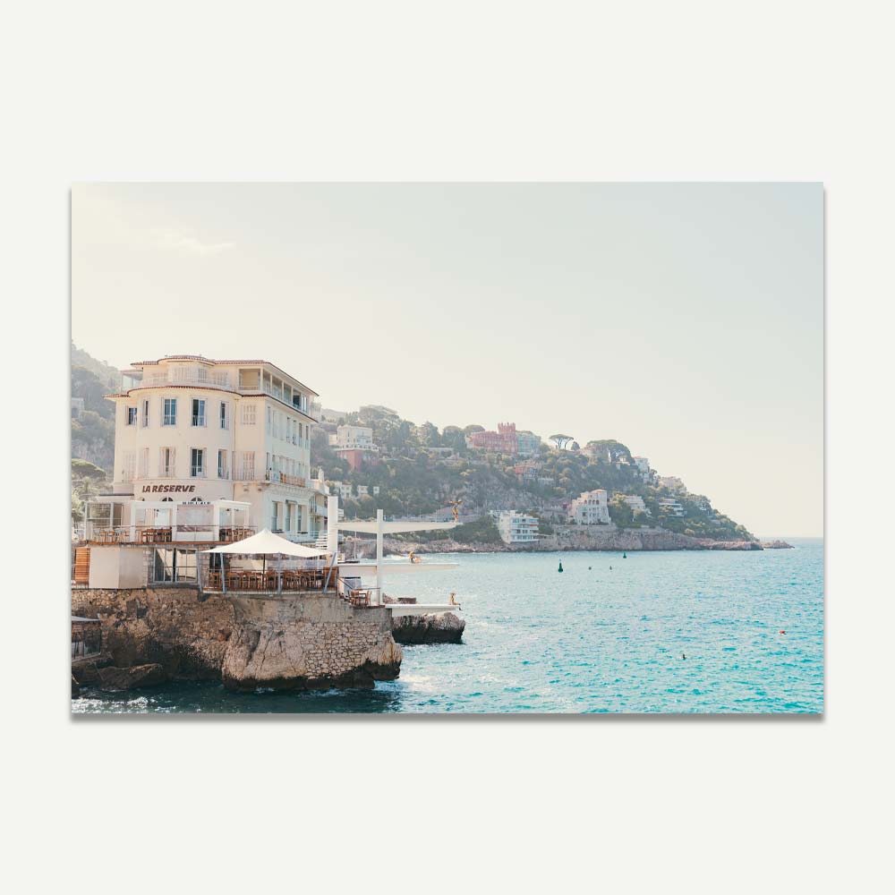 Art print of La Réserve building in Nice with brass statues diving into the Mediterranean Sea.








