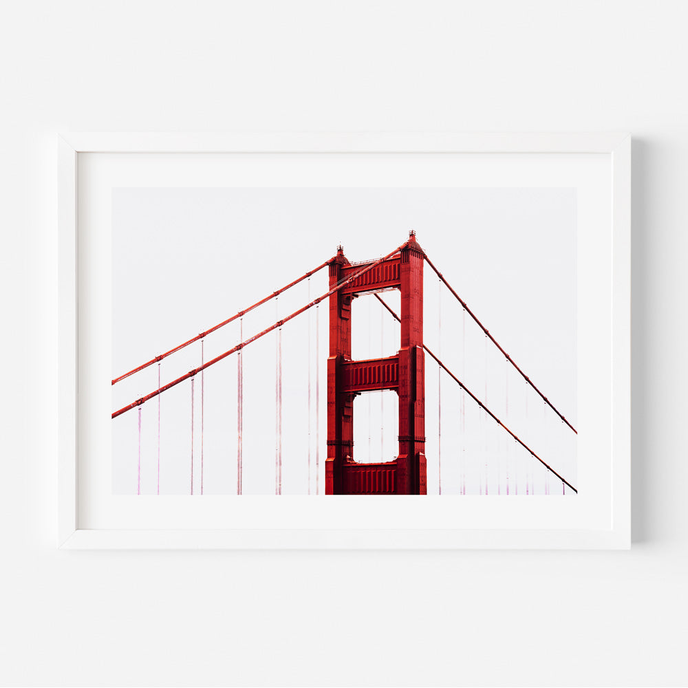 Golden Gate Bridge wall art featuring the iconic bridge tip emerging through a blanket of clouds