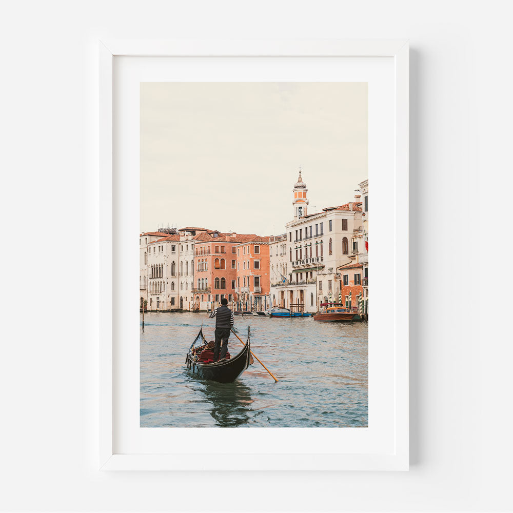 Gondola Tour: A framed photograph capturing the essence of a man boating in the water - perfect for wall art enthusiasts.