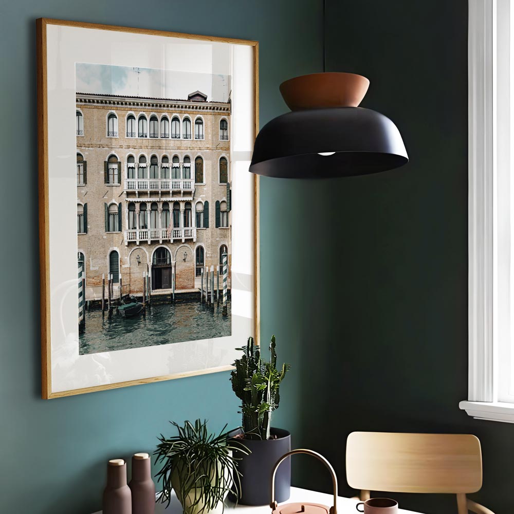 Venice, Italy: Green Poles along the picturesque waterfront with a charming building in the background - Ideal for canvas prints and fine arts.