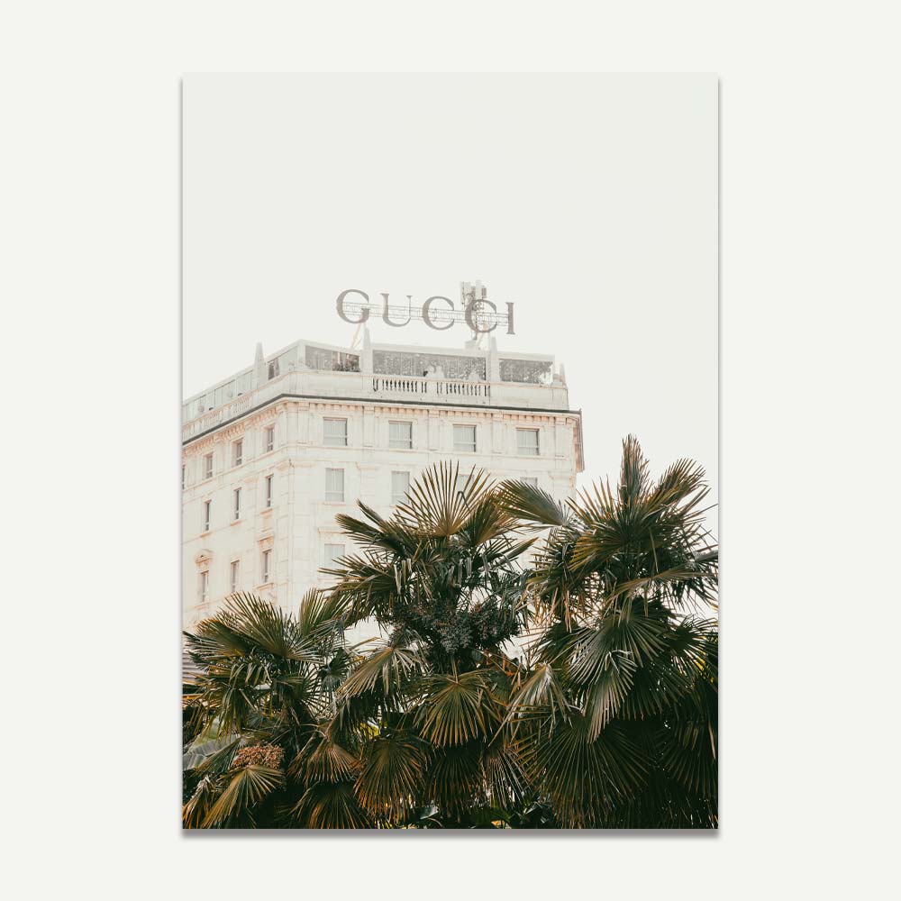Gucci sign on an old Milan building with palm trees – luxury fashion and architectural wall art for stylish home decor.