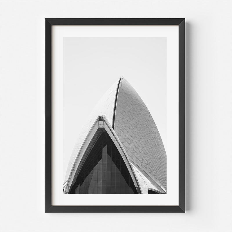 Framed black and white photograph of a modern architectural structure on a white background