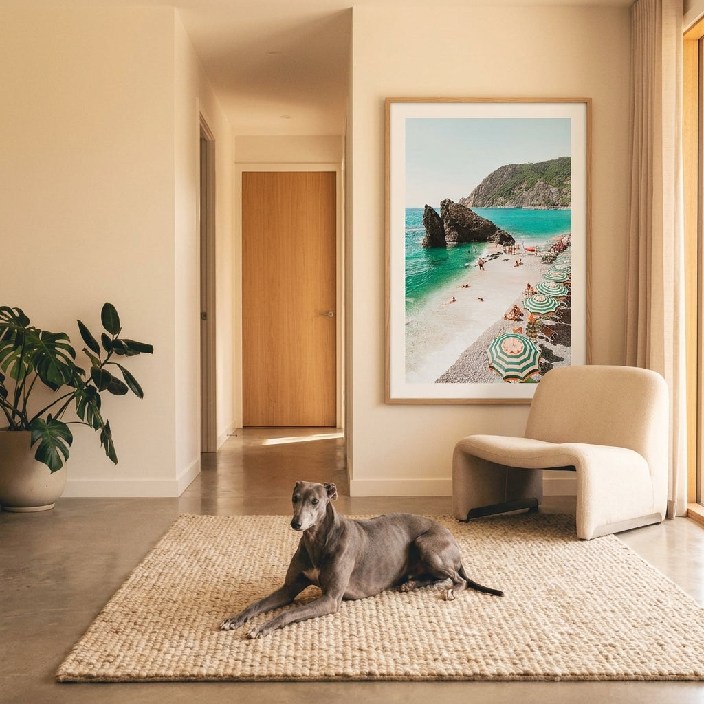 Dog lying on a rug in a modern living room with a large framed picture of a beach.