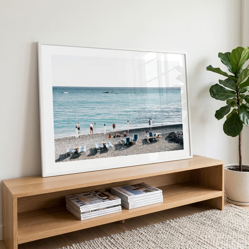 TV displaying a beach scene in a living room with a wooden shelf and plant.