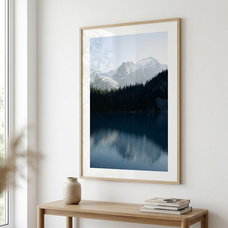Framed landscape print of a mountain lake in a modern interior setting.
