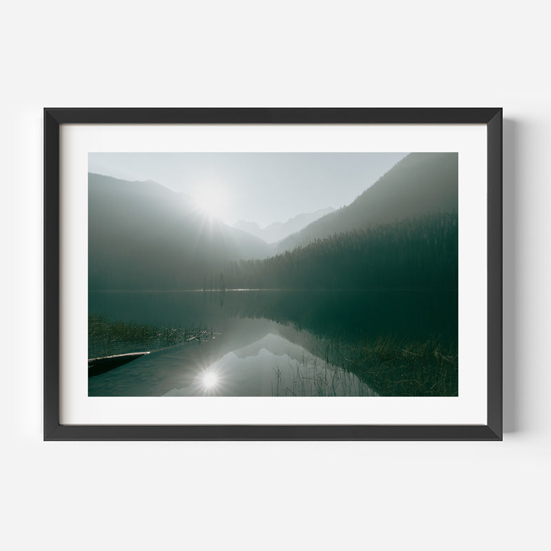 Framed photograph of a misty lake with mountains in the background