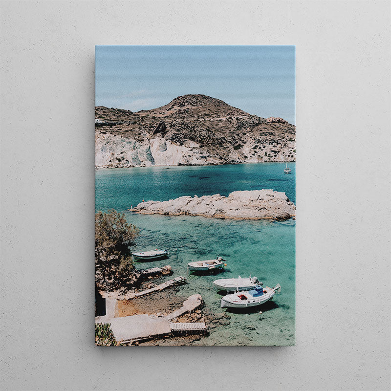 Canvas print of a coastal scene with boats and rocky cliffs.