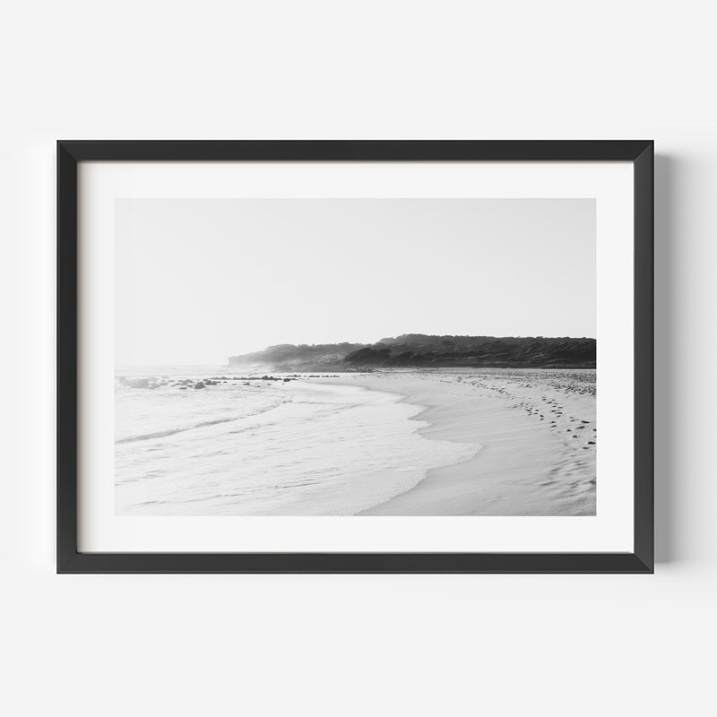 Framed black and white beach landscape on a white wall