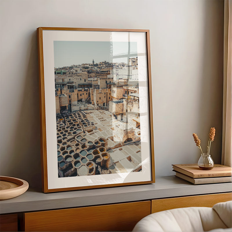 Framed photograph of a cityscape on a shelf with decorative items.