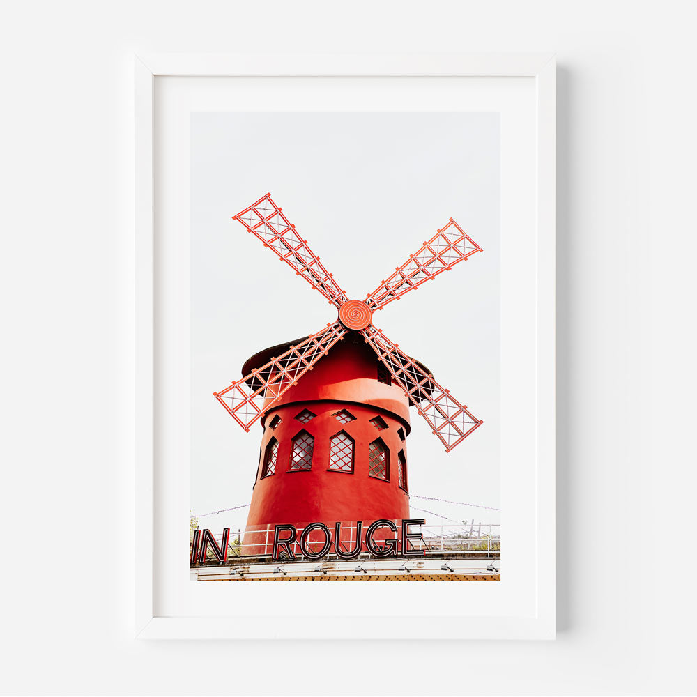 Moulin Rouge sign captured in the serene morning light of Montmartre, perfect Parisian wall decor.
