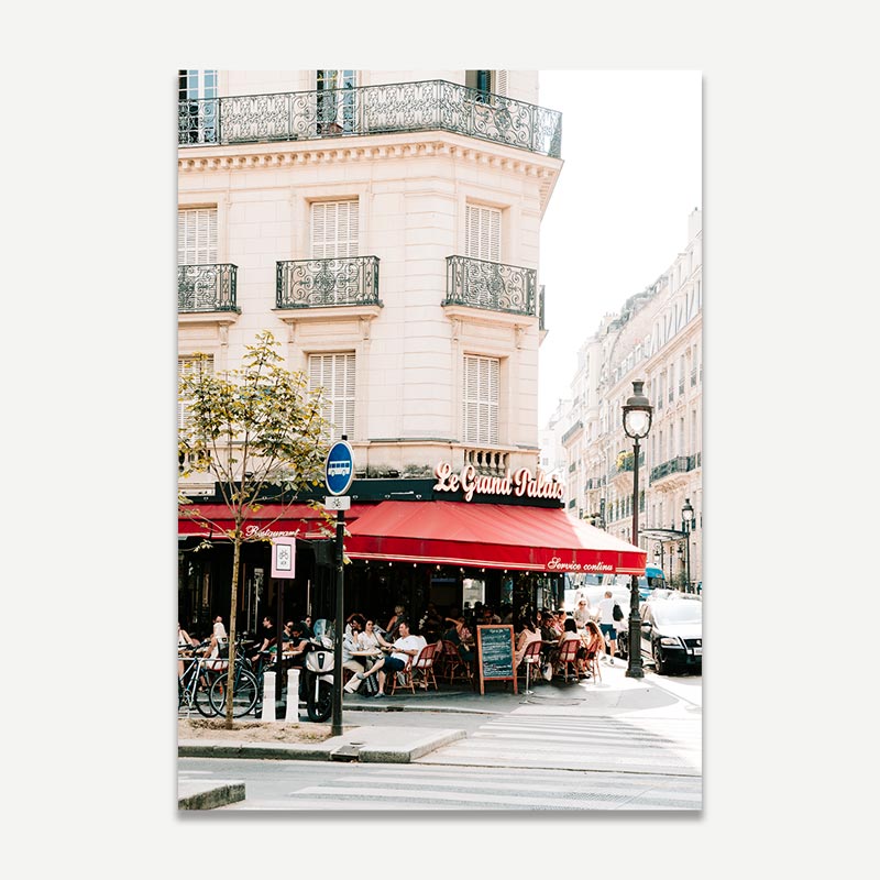 Street scene with a cafe named 'Le Grand Palais' in an urban setting