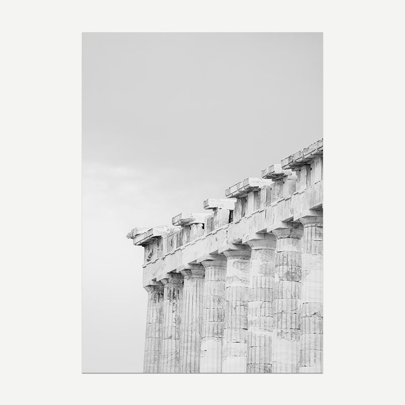 Ancient stone temple with columns against a light gray sky